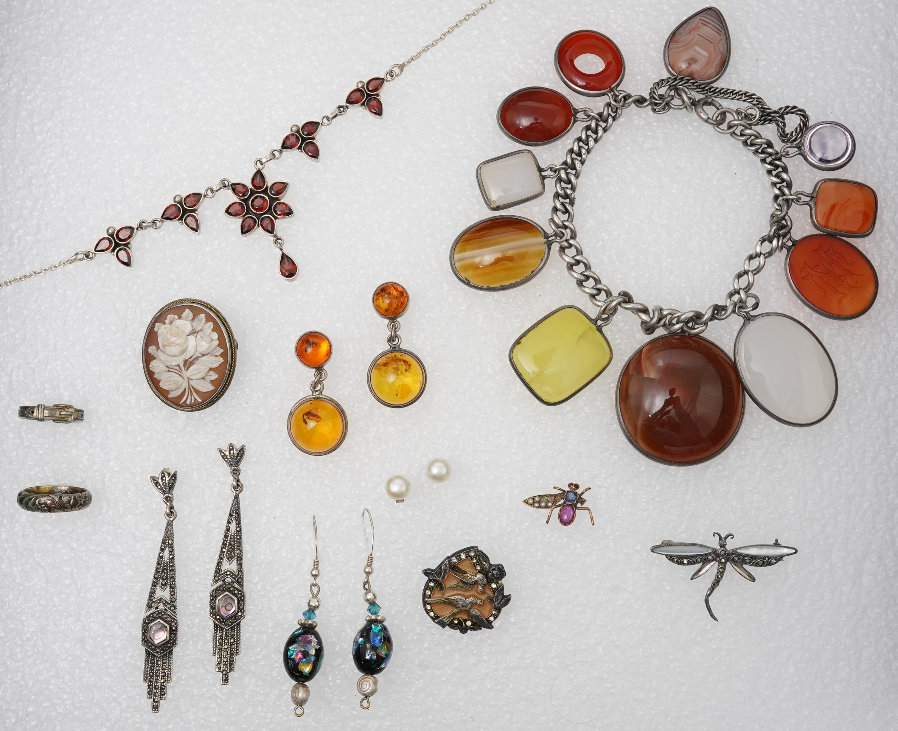 A small collection of costume jewellery to include a silver curb link charm bracelet, hung with assorted bezel set agate and carnelian drops, together with other silver and costume jewellery